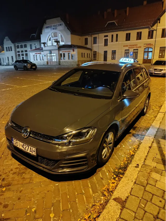 Taxi nocne w Żywcu – taksówka z podświetlonym kogutem przy dworcu po zmroku